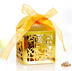 Golden laser-cut lovebird candy box with yellow ribbon for weddings and parties