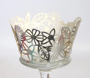 Detailed laser-cut cupcake wrapper with silver metallic floral and leaf hollow patterns