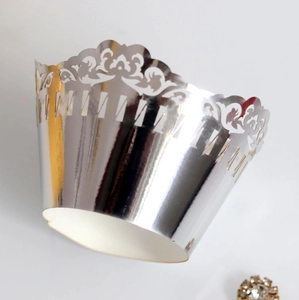 Laser cut lace cupcake wrappers in silver foil finish for elegant dessert table decor