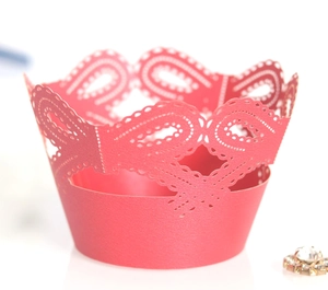 Detail of pink laser-cut lace crown cupcake wrapper made of pearlized cardstock