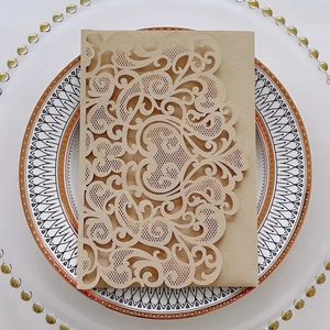 Elegant laser-cut wedding invitation featuring heart patterns on retro kraft paper card