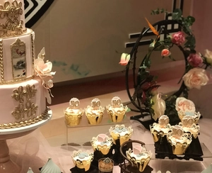 Detailed laser-cut hollow cupcake wrappers with pink floral design for 50th anniversaries