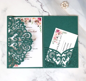 Detail of dark green laser-cut wedding invitation with floral card and RSVP pocket