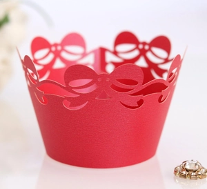 Detailed laser cut cupcake wrapper with bow patterns and elegant red pearlescent finish
