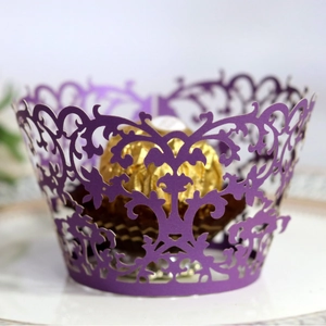 Deep purple laser-cut cupcake wrappers with elegant floral lace pattern decoration