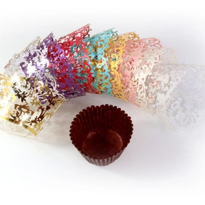 Laser-cut cupcake wrappers in multicolor metallic finishes with scroll plant patterns