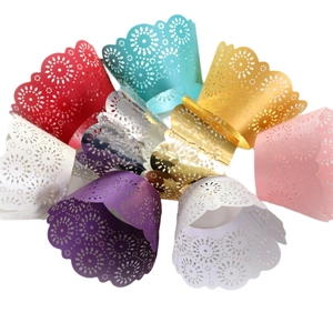 Laser cut floral cupcake wrappers in pearlescent colors for party and wedding decorations