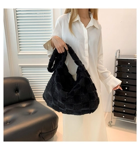 Detail of black plush checkered hobo shoulder bag styled with casual outfit
