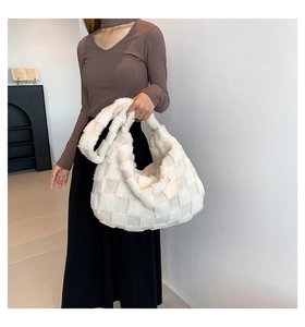 Macro detail of plush faux fur texture on a white checkered shoulder bag with soft finish