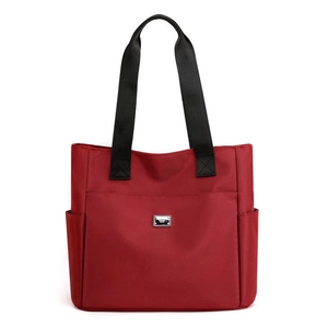 Minimalist red nylon tote bag with wide black handles and large capacity storage