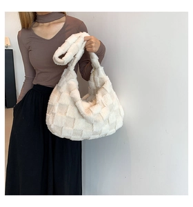 Detailed view of large white plush hobo bag with contrast checkerboard pattern texture
