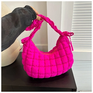 Hot pink quilted hobo bag with knotted strap and cloud texture shown on a white background