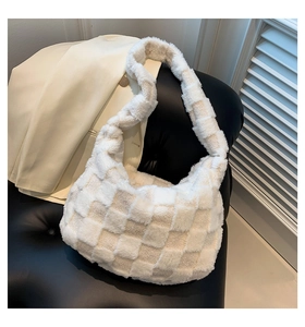 Detailed close-up of cream checkerboard plush shoulder bag with soft faux fur texture