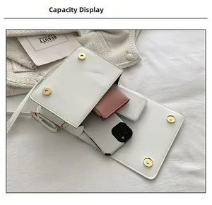 Interior view showing capacity for smartphone and wallet in white quilted crossbody bag