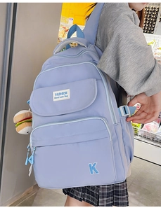 Detail of blue water-resistant backpack with cute hamburger plush and side buckle