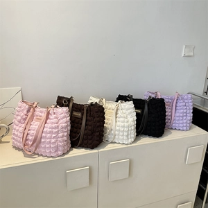 Minimalist pleated shoulder bags with bubble texture in five colors on display