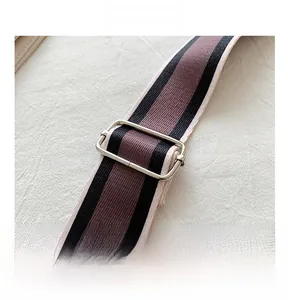 Close-up of adjustable woven shoulder strap with metallic silver buckle for camera bag