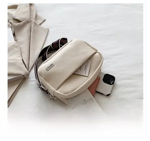 Internal capacity of the beige lychee grain bag showing phone and card storage