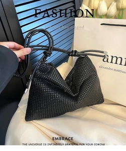 Macro shot of stylish black rhinestone bag with pleated texture and sparkling finish