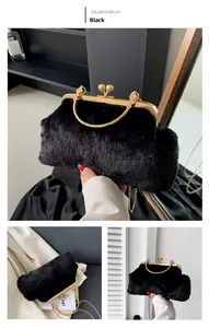 Detail of black faux fur evening bag featuring golden vintage embossed metal frame and chain