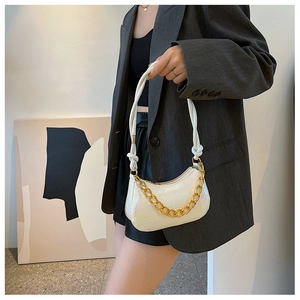 Detailansicht der weißen Mondsichel-Schultertasche mit goldener Kette und Knotenschultergurt