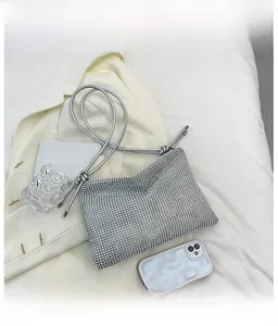 Detailed macro view of sparkling silver rhinestone surface and knotted soft shoulder strap