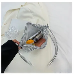 Silver rhinestone handbag showing interior space for phone and makeup accessories
