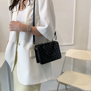 Minimalist black quilted crossbody bag with stylish thick chain and adjustable strap
