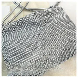Detail shot showing the shimmering silver rhinestones and delicate handle of the handbag