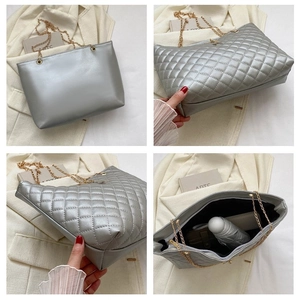 Detail der silbernen Metallic-Tasche mit Rautensteppung und goldener Kettenriemen