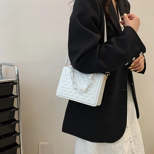 Minimalist white quilted shoulder bag with chain handle and brick pattern texture