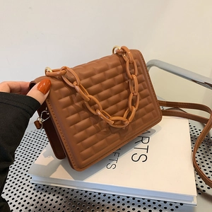 Brown quilted crossbody bag with chocolate pattern and stylish gold chain handle