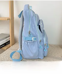 Detail view of water-resistant light blue nylon backpack with multiple zipper layers