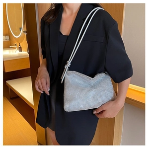 Elegant silver rhinestone baguette bag with knotted strap shown on model for women