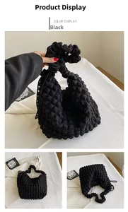 Detail of black puffy bubble texture shoulder bag with soft cloud design and minimalist style