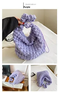 Detail view of purple textured bubble tote bag with soft pleated fabric and handle