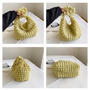 Detailed views of light yellow puffy cloud handbag with soft 3D popcorn texture