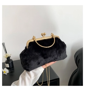 Detail view of black faux fur clutch bag with vintage gold metal frame and chain strap