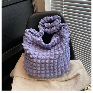 Detail of light purple bubble texture tote bag with soft pleated shoulder strap design