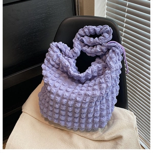 Detail showing the soft bubble texture and lavender pleated fabric of the large tote bag