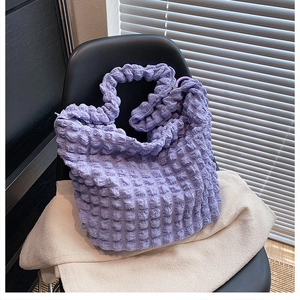 Detailed close-up showing the purple seersucker bubble texture on the large tote bag
