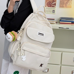 Minimalist cream white water-resistant school backpack with plush hamburger charm and pockets