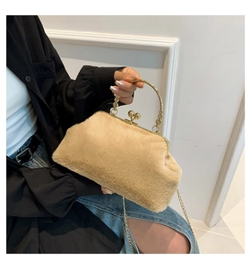Detailed shot of beige faux fur handbag featuring gold ring handles and chain strap