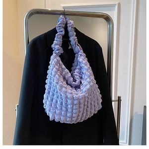 Detailed view of lilac waffle texture and soft bubble pleats on the cloud shoulder bag