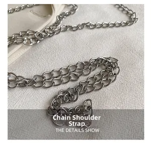 Detail shot of a silver metal chain strap with polished oval links for a handbag