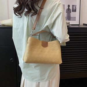 Chic light yellow tote bag with geometric honeycomb pattern and brown leather straps
