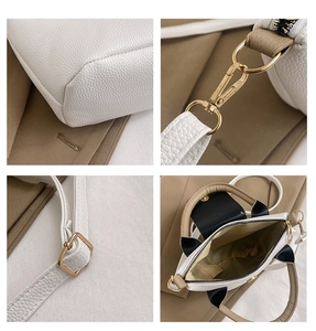 Détails d'un sac en cuir blanc avec fermetures éclair dorées et bandoulière réglable