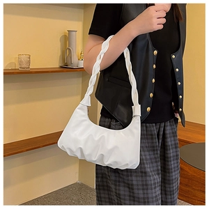 French style white ruched cloud bag with woven handle shown on shoulder with chic outfit