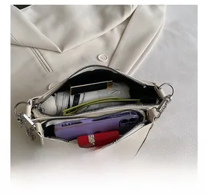 Overhead view showing double zipper compartments and interior storage of this beige bag
