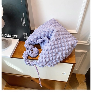 Detail of light purple puffy cloud bag showing soft bubble texture and gathered strap